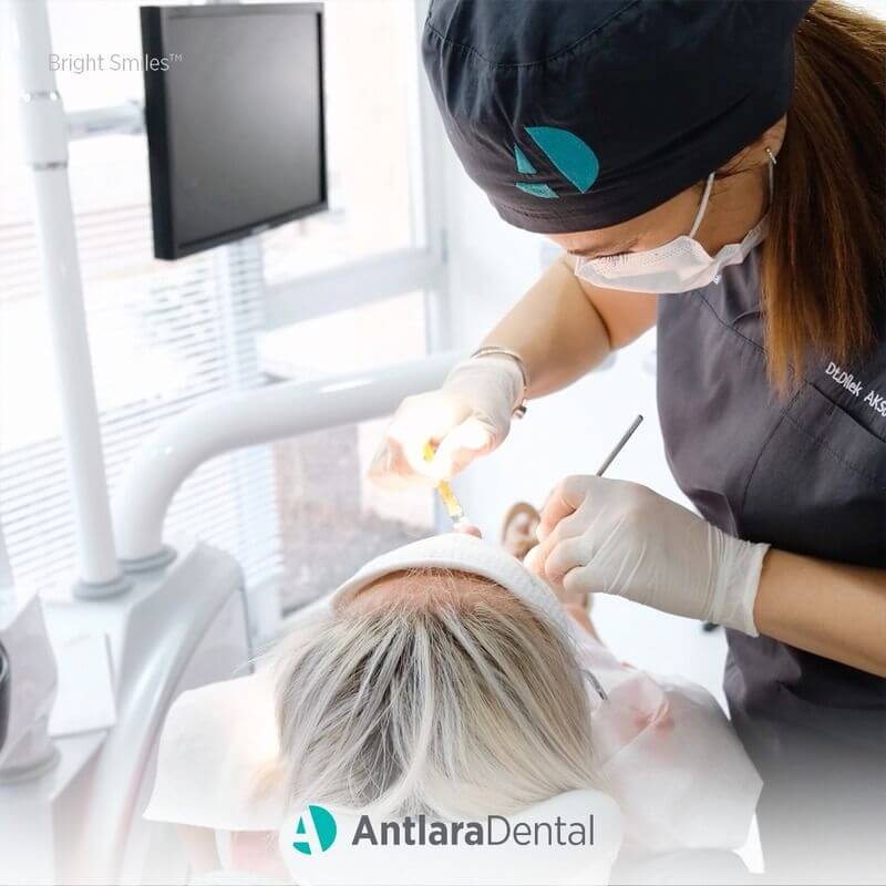 dentist doing laminate veneers treatment at dental clinic