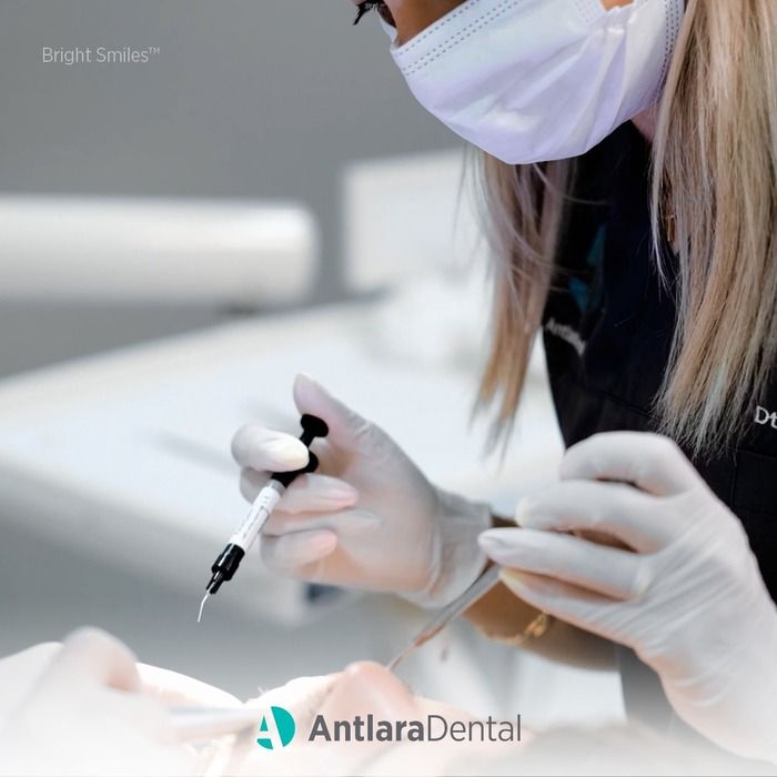 a Women dentist doing dental treatment with her equipment
