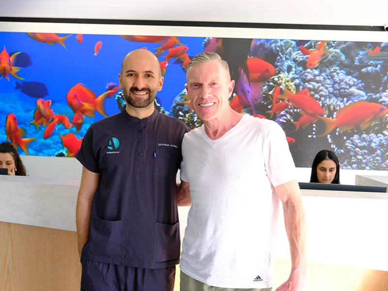 patient smiles after having emax crown treatment