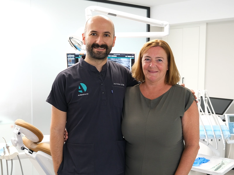 Dt. Dilek and her patients stands side by side after having dental implant operation