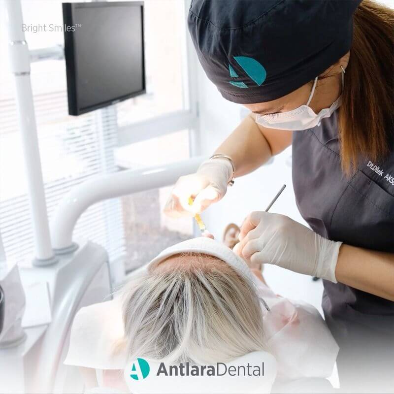 dentist carry out cosmetic dentistry operation wiith patient in Antalya