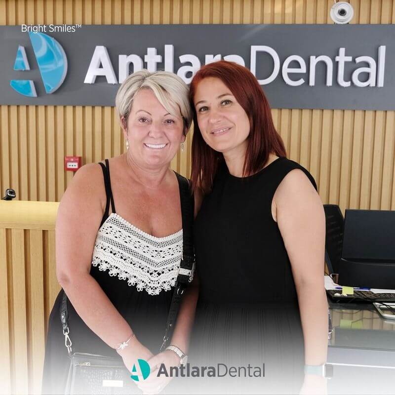 patient and doctors stands next to the each other and smiles 