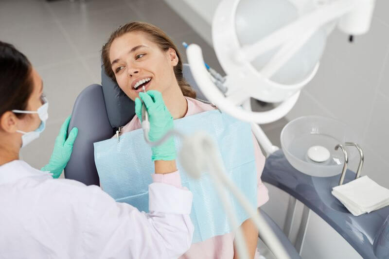 women sit on dentist seat and happy for coming dental tourism.