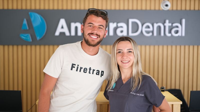 antlara dental dentist with her patient have lamşnate veneers and giving pose for camera