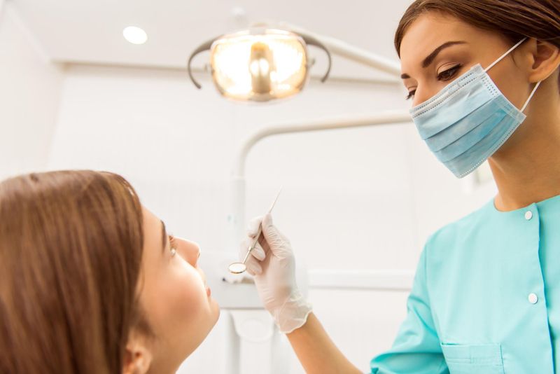 dentist checking patient teeth with a dental instrument in antalya turkey