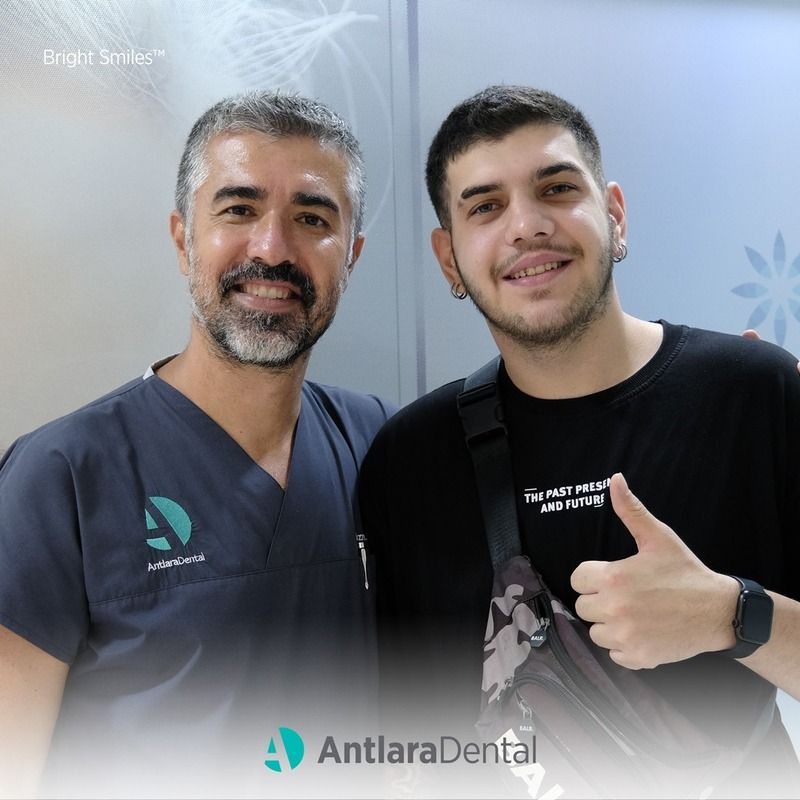 dentist and patient smiles after having Periodontal Treatments in Turkey