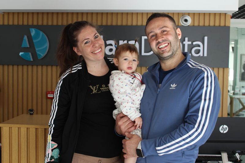 a happy family giving pose after porcelain veneers in antalya Turkey